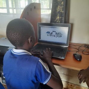 Kujenga students actively learning essential computer education and digital skills at their desks.